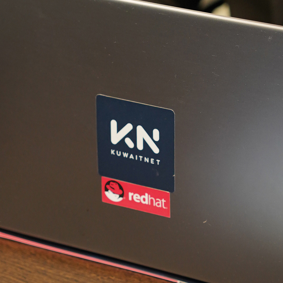 logo of KUWAITNET and Red Hat Premier partnership on the back of a laptop symbolizing how KUWAITNET is the best company to handle implementing Red Hat solutions locally.